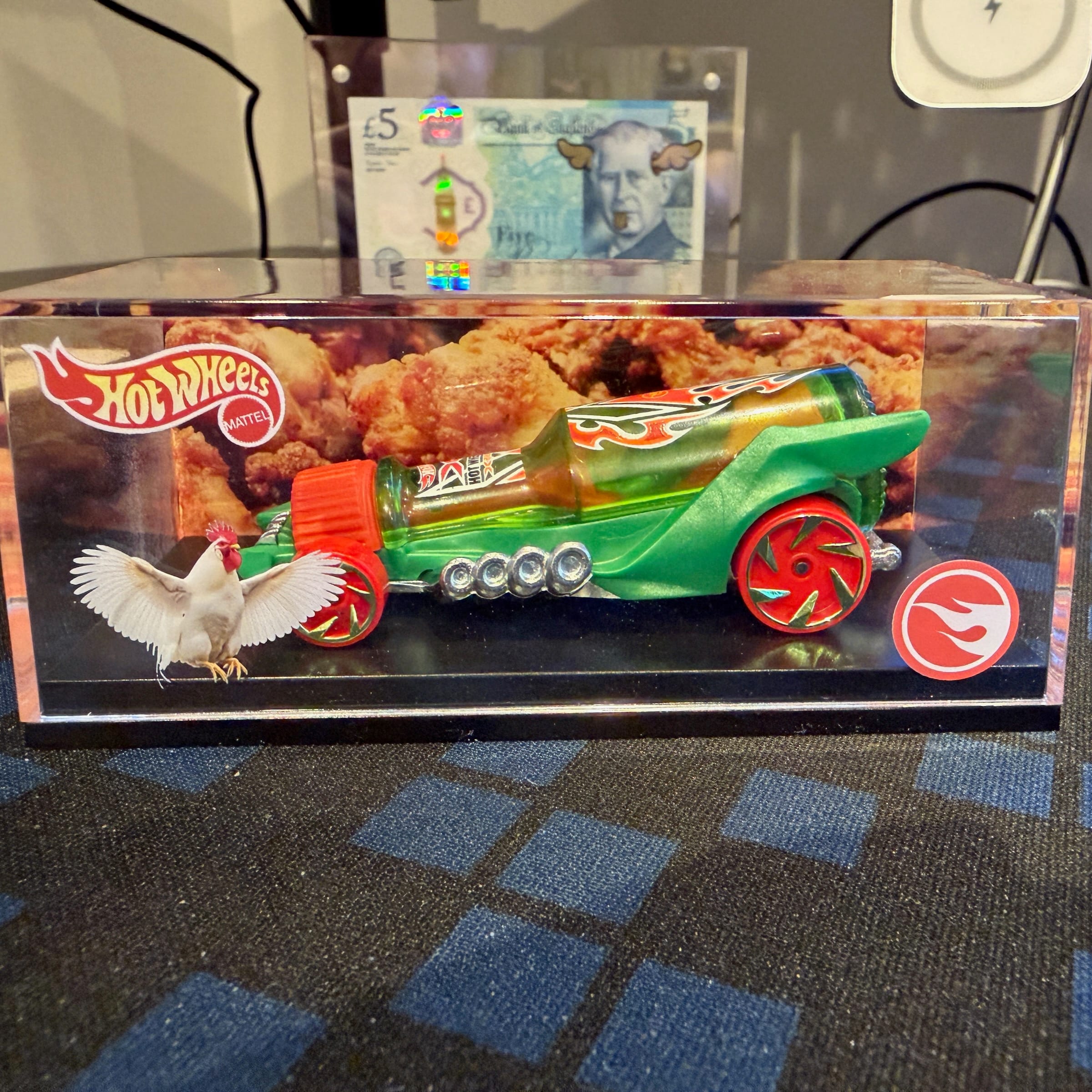 Hot Wheels green toy car in display case